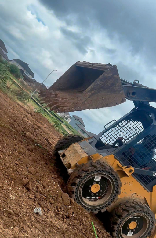 Skid-steer dirt work and grading on a job site